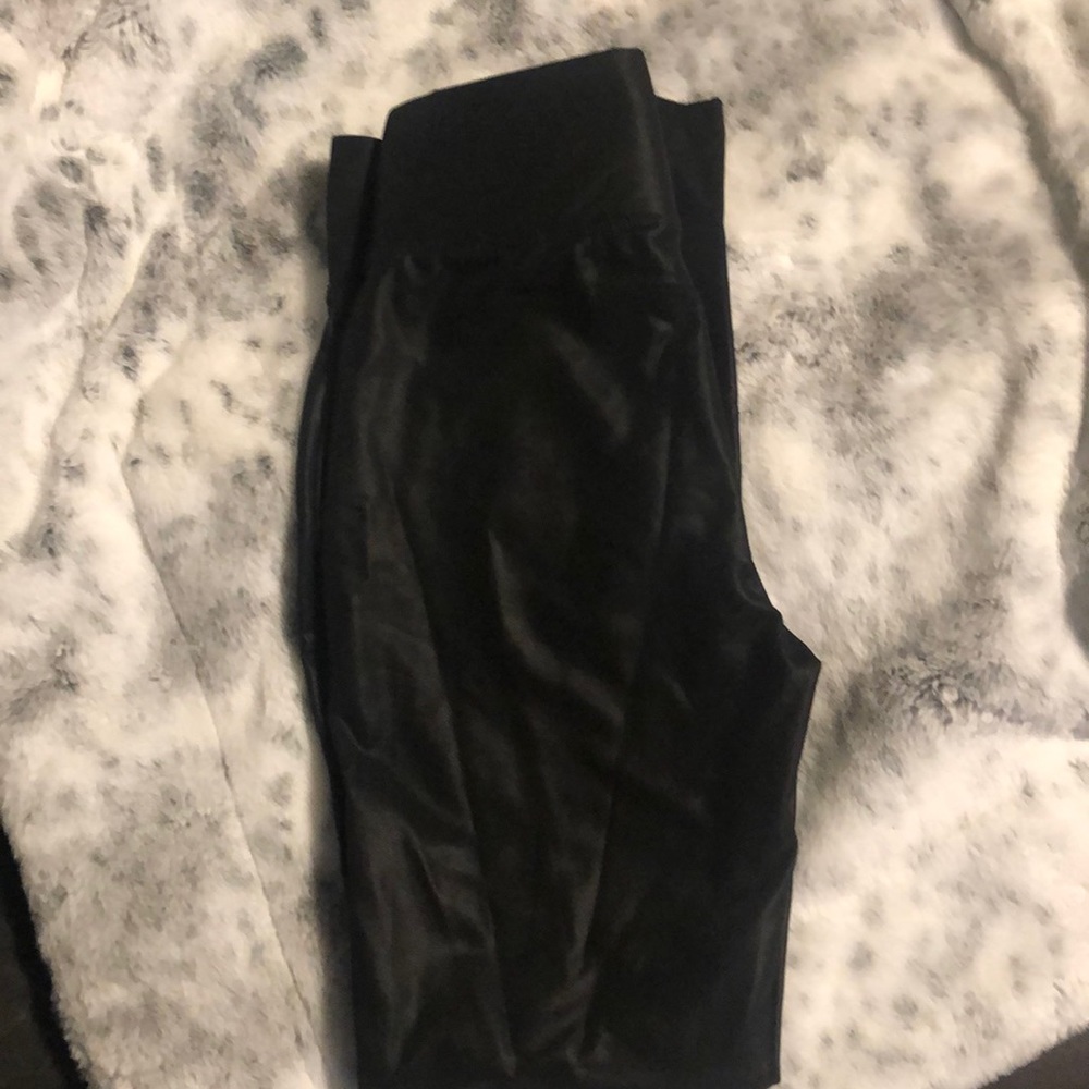Black leather-like leggings.